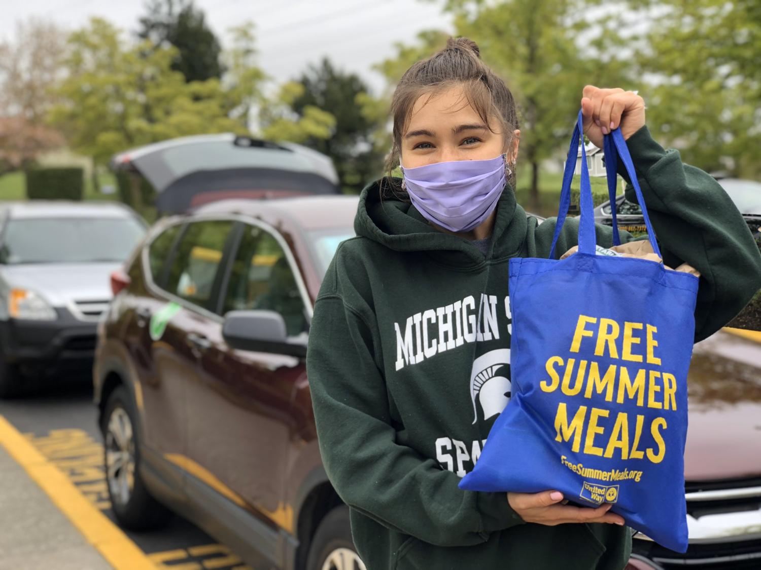 AmeriCorps member carries groceries