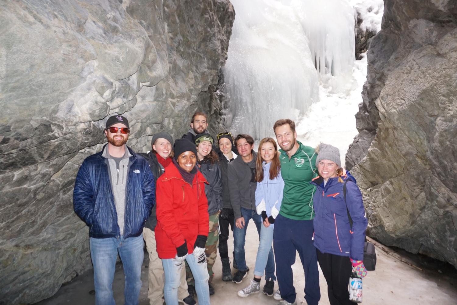 AmeriCorps members taking a picture together at frozen waterfalls