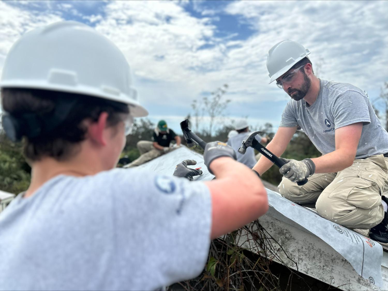 AmeriCorps team members repairing a damaged roof