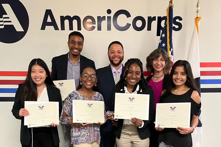 CEO Michael D. Smith presented President’s Volunteer Service Awards to five students from The George Washington University