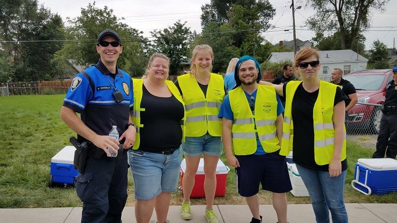 Mikah serving with fellow volunteers and the homeless population in his community